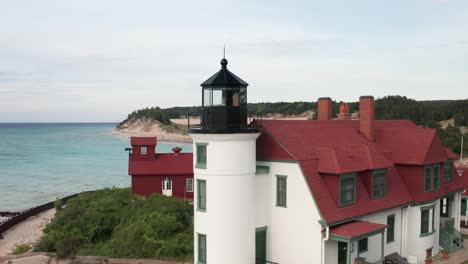 Historic-Point-Betsie-Lighthouse-in-Frankfort,-Michigan-located-along-Lake-Michigan-with-drone-video-close-up-on-the-side-moving-in