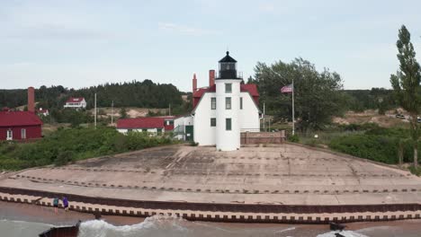 Historic-Point-Betsie-Lighthouse-in-Frankfort,-Michigan-located-along-Lake-Michigan-with-drone-video-flying-overhead