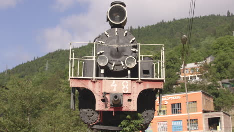 Retro-Kukushka-Train-Exhibit-With-Forest-Mountain-At-Background-In-Borjomi-Bakuriani,-Georgia