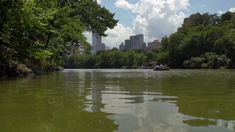 Row-boats-in-the-Central-Park-against-a-background-of-New-York-City-skyline