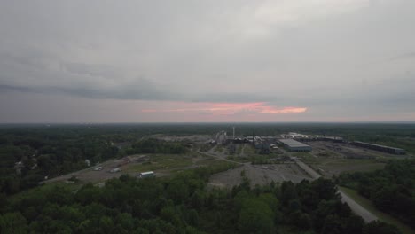 Aerial-drone-forward-moving-shot-over-a-large-woodworking-factory-on-a-cloudy-evening