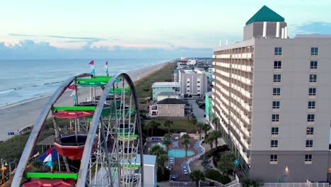 Aerial-over-the-ferris-wheel-at-carolina-beach-nc,-north-carolina-boardwalk-amusement-park