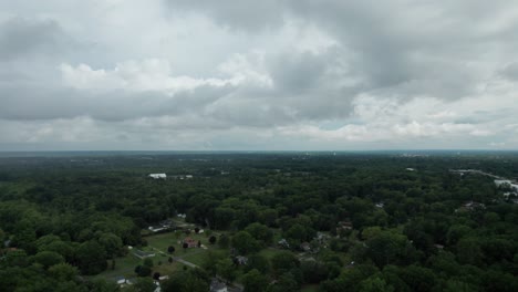 Drone-capture-the-town-surrounded-by-the-numerous-trees-with-multiple-building-from-the-great-height