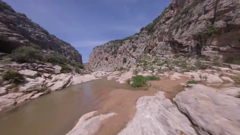 FPV-close-proximity-aerial-flight-up-rugged-rocky-river-canyon-gorge