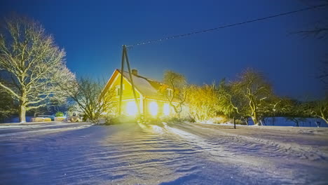 Hütte-In-Der-Winterlandschaft-Mit-Sternen-Und-Wolken-Am-Nachthimmel,-Während-Die-Lichter-Der-Hütte-Leuchten---Zeitraffer