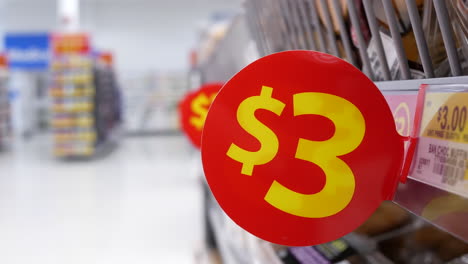 The-motion-of-a-three-dollars-price-tag-on-display-food-inside-a-Walmart-store-with-4k-resolution