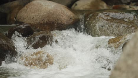 Water-flowing-through-rocky-river-120fps