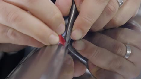 Hands-Holding-Tweezers-and-Plastic-Tool-for-Car-Wrapping-Process-CU