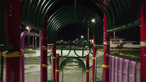 Reverse-shot-of-a-kids-playground-at-night