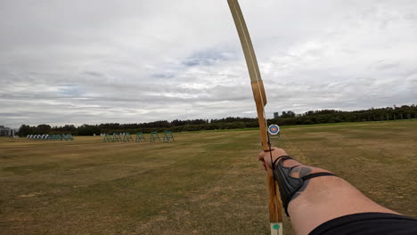 POV-An-archer-fires-arrows-from-his-bow-at-a-target-on-the-archery-range
