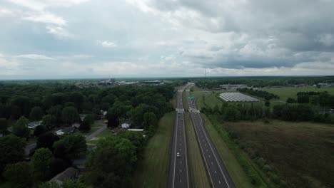 On-a-cloudy-day,-a-drone-was-used-to-capture-the-busy-highway-with-many-cars-moving-up-and-down-in-speed