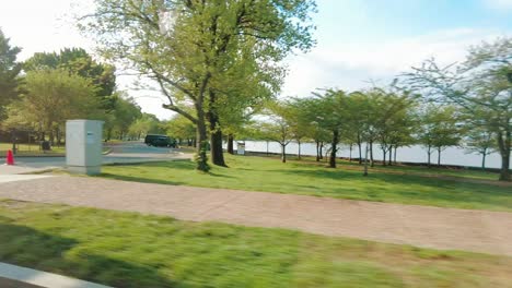 Full-screen-view-of-driving-past-the-Jefferson-memorial-with-flowers-in-the-area