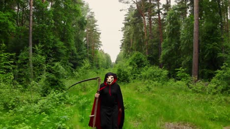 Scary-Grim-Reaper-With-Scythe-Walking-In-The-Forest