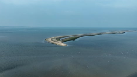 Aerial-view-over-sandy-islet-with-dunes-in-Rockanje---natural-flood-protection