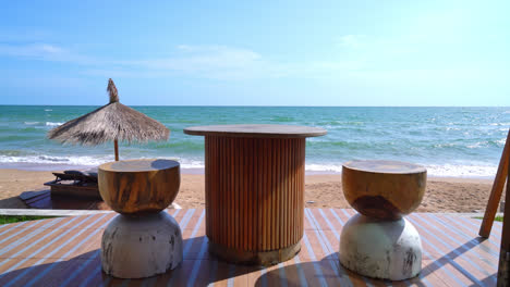 Wood-table-and-chair-on-balcony-with-sea-beach-background