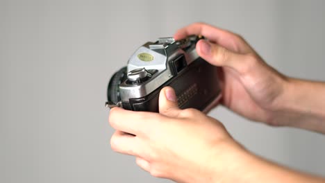 Hands-advance-film-lever-and-take-photo-with-vintage-camera,-close-up
