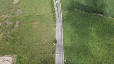 Aerial-view-of-a-little-traveled-road-with-crop-fields