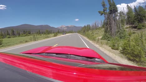 Red-Car-driving-through-Rocky-Mountain-National-Park