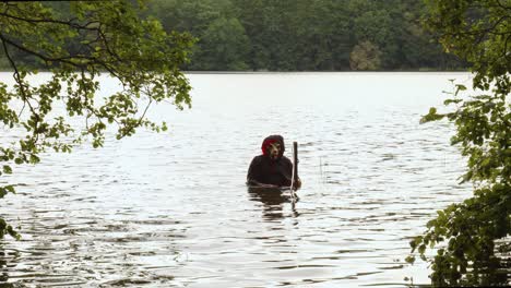 Grim-Reaper-With-Scythe-Submerged-In-The-River-Water