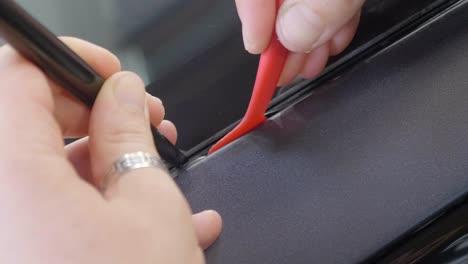Plastic-Tool-Pushing-Car-Wrapping-Vinyl-into-Car's-Exterior-Seam