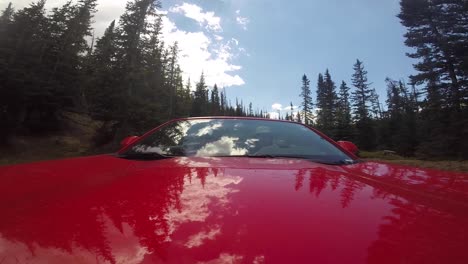 Red-Car-With-Two-Men-driving-through-Rocky-Mountain-National-Park