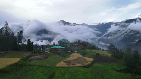 Drone-Shot-of-a-cloudy-Sainj-Valley-in-Himachal-Pradesh-near-Manali,-Kasol-1