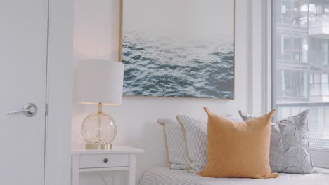 Showing-a-condominium-badroom-that-with-a-single-size-bed-inside-and-night-lamp-at-the-side-and-a-water-wave-photography-on-the-wall