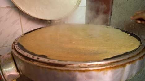Cooking-process-of-the-traditional-Ethiopian-injera-bread,-Ethiopia