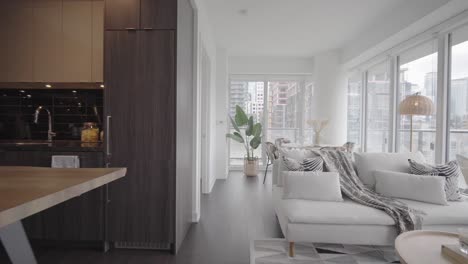 Wide-angle-orbit-push-in-shot-from-the-kitchen-and-living-area-to-dinning-area-and-also-shows-the-balcony-and-the-bedroom-through-the-door-in-a-condominium-unit
