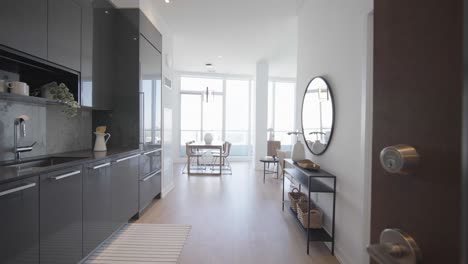 Door-opening-intro-enter-into-a-cozy-high-rise-residential-penthouse-unit-in-a-condominium-during-a-sunny-day