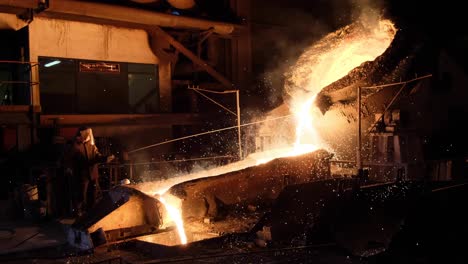 Pouring-liquid-molten-metal-in-a-smelting-furnace-with-a-steel-mill,-heavy-industry-and-metallurgic-concept