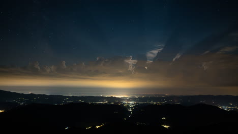 Twilight-time-lapse-at-sunset-and-stars-appears-in-night-sky---lightning-and-rain-on-coastline-with-golden-horizon,-Tuscany,-Italy