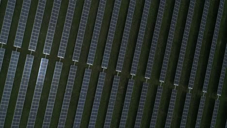 Aerial-view-of-large-solar-farm-with-hundreds-of-rows-of-energy-efficient-panels,-sustainable-renewable-energy