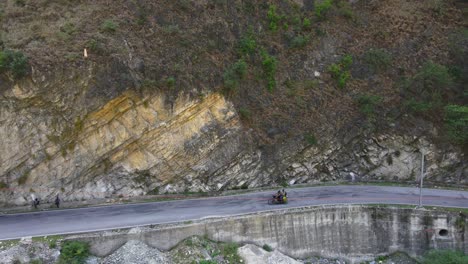 Drone-Shot-of-a-bike-and-road-in-Himachal-Pradesh-near-Manali,-Kasol