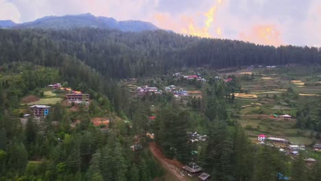 Drone-Shot-of-sunset-in-a-small-village-in-Sainj-Valley-in-Himachal-Pradesh-near-Manali,-Kasol-2