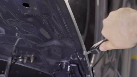 Mechanic-Using-Heat-Blower-on-Vinyl-Foil-Applied-to-Car's-Hood