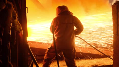 Workers-working-in-a-metal-smelting-furnace-and-steel-mill,-Molten-metal-and-metallurgy-concept-or-steel-casting-foundry