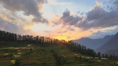 Drone-Shot-of-sunset-in-a-small-village-in-Sainj-Valley-in-Himachal-Pradesh-near-Manali,-Kasol-1