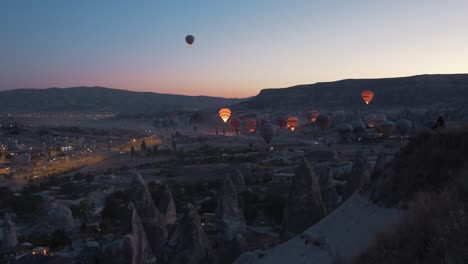 Spectacular-wide-shot-over-Cappadocia-Goreme-hot-air-balloons-take-off