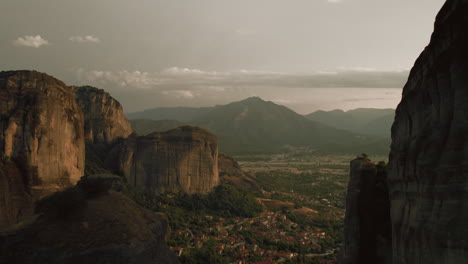 Epic-aerial-among-rock-formations-of-Meteora,-Greece-at-sunset