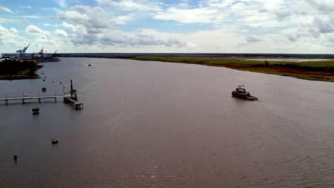 Tug-boat-cruises-down-the-cape-fear-river-in-wilmington-nc,-north-carolina