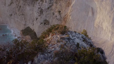 Aerial---Beach-reveal-behind-cliff-in-Keri,-Zakynthos