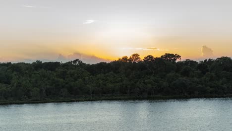 Crane-shot-of-sun-setting-in-Clear-Lake-city,-Texas