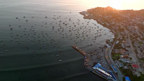 Aerial-dolly-in-view-of-Tongoy-creek-with-many-boats-moored-under-the-sunset-light