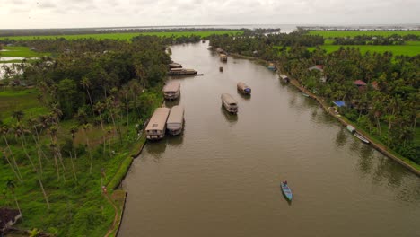 Aerial-view-of-several-houseboats-sailing-in-tropical-backwaters-of-Kerala