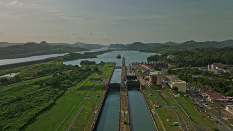 Panama-City-Aerial-v29-drone-flyover-industrial-attraction-miraflores-locks-with-cargo-tanker-ship-on-narrow-canal-waterway,-waiting-for-the-sluice-gate-to-open---Shot-with-Mavic-3-Cine---March-2022