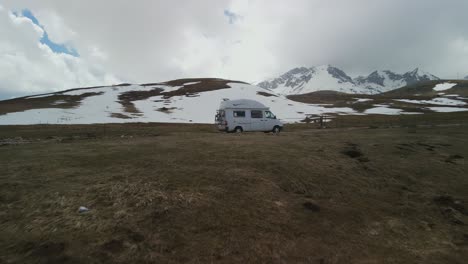 Moving-toward-camper-van-parked-on-dirt-road,-Montenegro-mountain-top