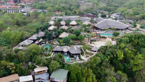 Luxury-villa-resort-with-pools-in-Bali-island,-aerial-orbit-view