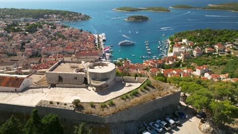 Aerial-approach-of-Hvar-harbor-over-the-castle-overlooking-the-harbor