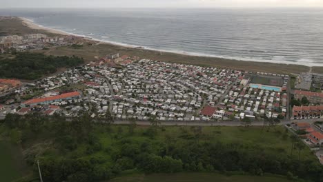 Aerial-view-of-an-caravan-park-with-a-yellow-beach-near